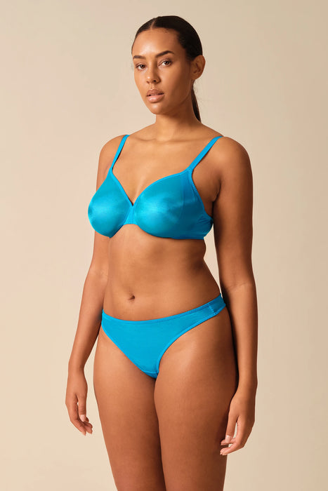 Curvy model in Gossard Glossies Sheer Bra Atomic Blue paired with matching thong, showcasing inclusive sizing and smooth underwire support.