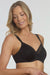Dominique Mallory Smoothing Comfort Underwire Minimizer Bra Black with seamless cups and sheer neckline, offering shaping and support.