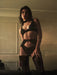 Model wearing full Sheer Lace Plunge Bra Donarella lingerie set with garter belt and stockings, styled for a sultry evening look.