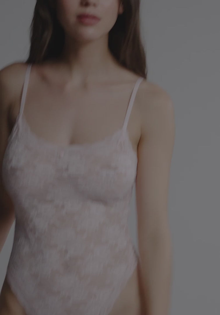 Blurry image of Soft Mesh Lace Bodysuit Blush Rosette Pink showing sheer lace and thin straps. Sensual and stylish lingerie by Blush Lingerie.