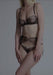 Full lingerie set featuring Sheer Scallop String Panty Blush Lulu with matching bra and garter belt, styled in sheer black mesh with blush accents.