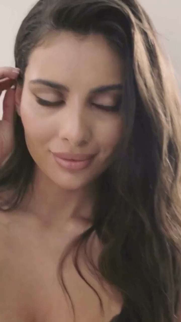 Close-up of model wearing Stelisa sheer mesh lingerie set. Elegant black bra and thong with soft makeup and natural lighting.