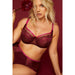 Model posing in Kinga Love Promise Soft Lace Panty and bra set against red background, emphasizing the romantic lace design.