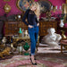 Model wears Amoralle Be Daring Bodysuit with cuffed jeans and stilettos in a vintage room, showcasing its couture appeal and adaptability.